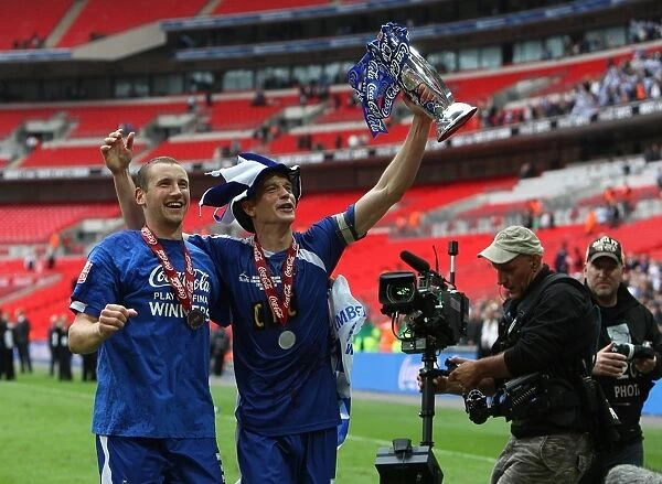Millwall's Triumph: Frampton and Robinson Rejoice with the Football League One Play-Off Trophy at Wembley