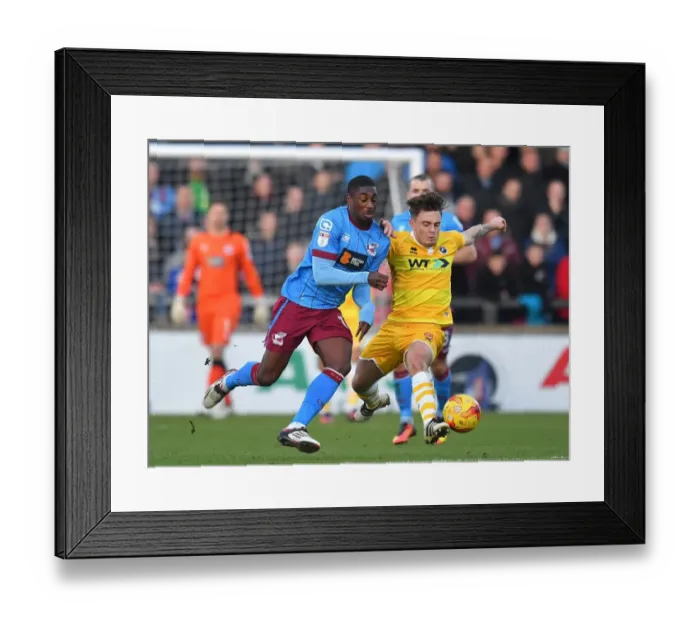 Framed Print : Hakeeb Adelakun vs Millwall: Intense Battle for Possession at Scunthorpe United's Glanford Park Framed Print : Hakeeb Adelakun vs Millwall: Intense Battle for Possession at Scunthorpe United's Glanford Park