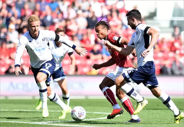Bristol City vs Millwall: Intense Battle for the Ball between Bobby Reid and Conor McLaughlin