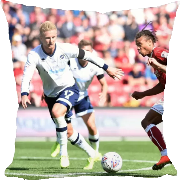 Bristol City vs Millwall: Intense Battle for the Ball between Bobby Reid and Conor McLaughlin
