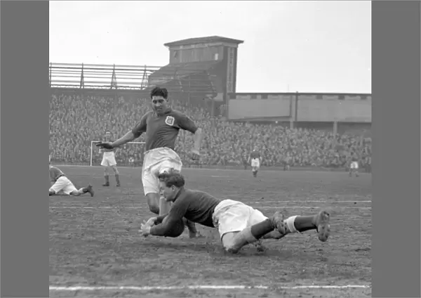Intense Moment: Ken Chisholm Tackles Malcolm Finlayson in Millwall vs Leeds United Soccer Match