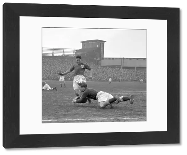 Intense Moment: Ken Chisholm Tackles Malcolm Finlayson in Millwall vs Leeds United Soccer Match