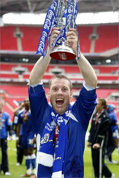 The Glory of Millwall: Neil Harris's Triumphant Moment with the Football League One Play-Off Trophy at Wembley Stadium