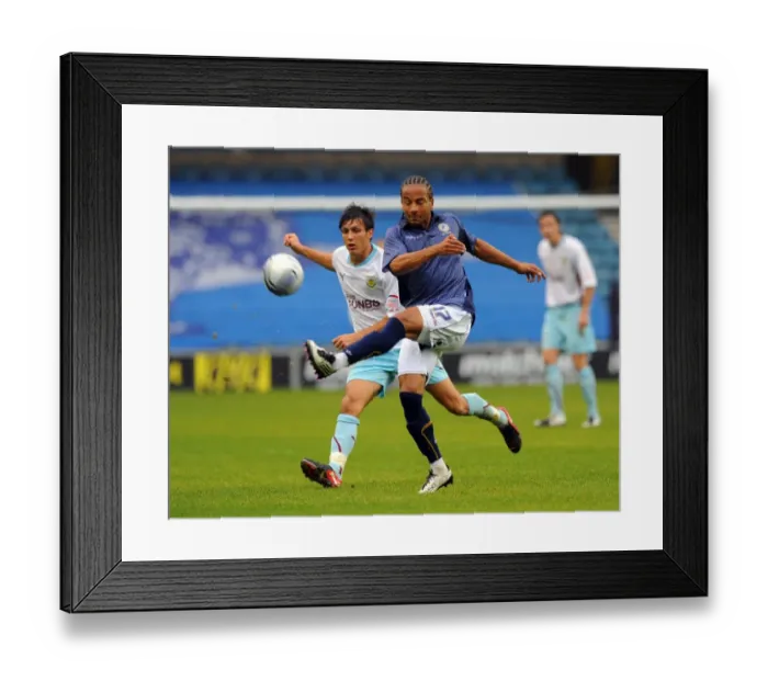Framed Print : Battle for Supremacy: Mkandawire vs. Cork in the Npower Championship Clash between Millwall and Burnley at The New Den Framed Print : Battle for Supremacy: Mkandawire vs. Cork in the Npower Championship Clash between Millwall and Burnley at The New Den