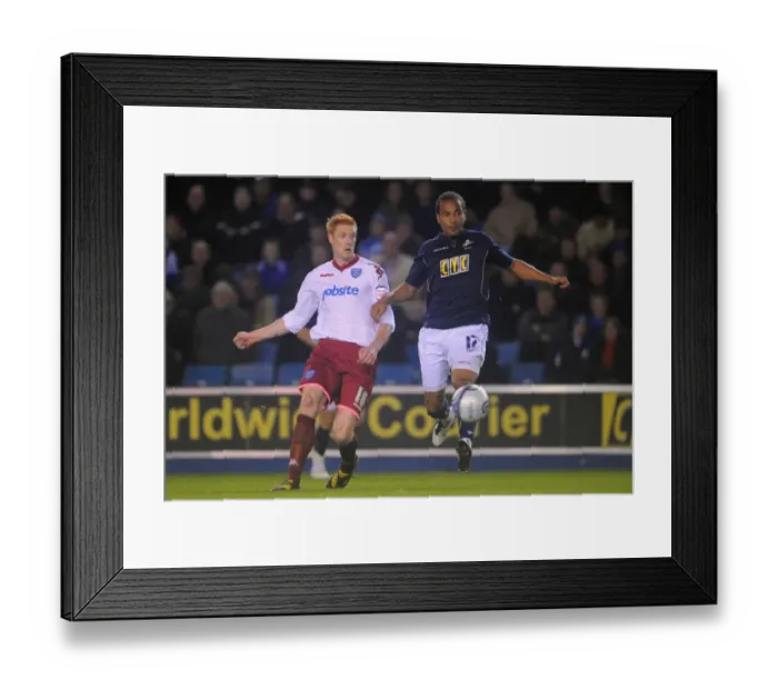 Framed Print : Millwall vs Portsmouth: A Championship Clash - Tamika Mkandawire vs Dave Kitson at The New Den (19-10-2010)
