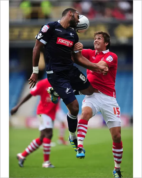 Millwall vs. Nottingham Forest: Intense Aerial Battle between Liam Trotter and Chris Cohen in the Npower Championship (13-08-2011)