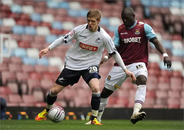 Clash at Upton Park: Andrew Keogh vs. Abdoulaye Faye in Npower Championship Showdown (Millwall vs. West Ham United, 04-02-2012)