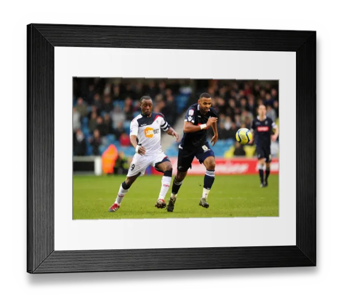 Framed Print : Millwall vs. Bolton Wanderers: Fifth Round FA Cup Clash - Intense Battle Between Nigel Reo-Coker and Liam Trotter Framed Print : Millwall vs. Bolton Wanderers: Fifth Round FA Cup Clash - Intense Battle Between Nigel Reo-Coker and Liam Trotter