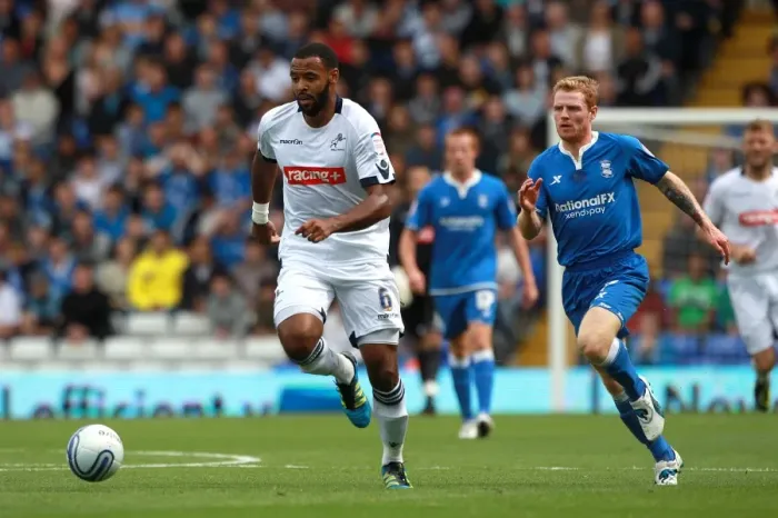 Framed Print : Chasing Glory: Burke Pursues Trotter in Intense Championship Clash between Birmingham City and Millwall