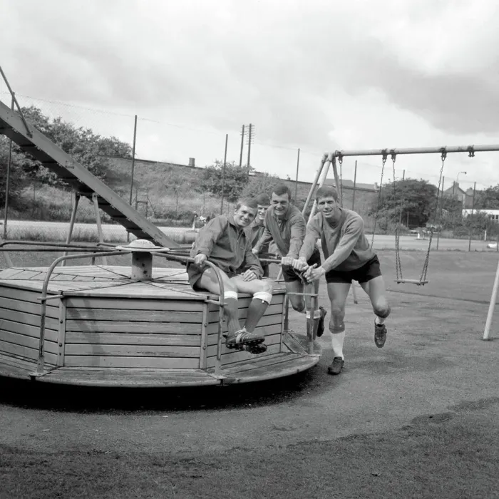 Framed Print : Millwall Football Club: Pre-Season Laughs - New Signing Derek Possee Rides a Roundabout with Team-Mates Lawrie Leslie, Keith Weller, and William Neil