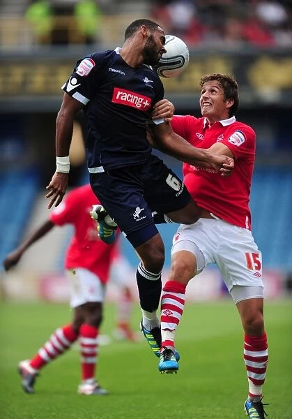 Millwall vs. Nottingham Forest: Intense Aerial Battle between Liam Trotter and Chris Cohen in the Npower Championship (13-08-2011)