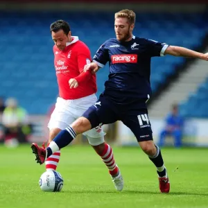 Battle for Supremacy: Millwall's James Henry vs. Nottingham Forest's Andy Reid in the Npower Championship Clash (Millwall v Nottingham Forest, The Den, 13-08-2011)