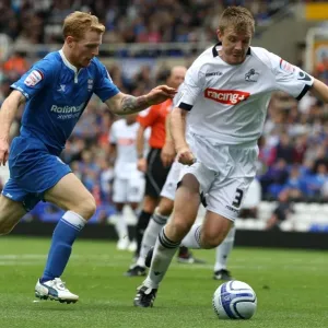 Battling for Supremacy: Burke vs. Craig in Millwall vs. Birmingham Championship Clash