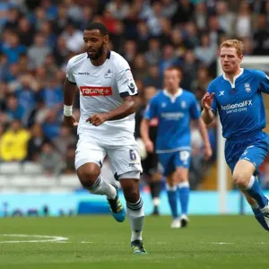 Chasing Glory: Burke Pursues Trotter in Intense Championship Clash between Birmingham City and Millwall