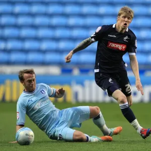 Clash at Ricoh Arena: Sammy Clingan Tackles Andy Keogh in Millwall vs. Coventry City Championship Showdown