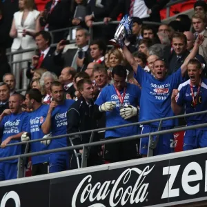 Millwall Football Club: Steve Morison Lifts the League One Play-Off Trophy at Wembley Stadium (The Triumphant Moment) Millwall Football Club: Steve Morison Lifts the League One Play-Off Trophy at Wembley Stadium (The Triumphant Moment)