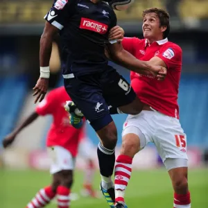 Millwall vs. Nottingham Forest: Intense Aerial Battle between Liam Trotter and Chris Cohen in the Npower Championship (13-08-2011)
