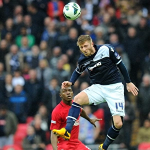 Millwall vs Wigan Athletic: FA Cup Semi-Final Showdown at Wembley Stadium - James Henry Leaps for a Header