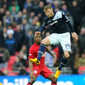 Millwall vs Wigan Athletic: FA Cup Semi-Final Showdown at Wembley Stadium - James Henry Leaps for a Header Millwall vs Wigan Athletic: FA Cup Semi-Final Showdown at Wembley Stadium - James Henry Leaps for a Header