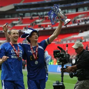 Millwall's Triumph: Frampton and Robinson Rejoice with the Football League One Play-Off Trophy at Wembley