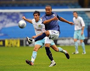 Battle for Supremacy: Mkandawire vs. Cork in the Npower Championship Clash between Millwall and Burnley at The New Den