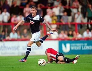 Images Dated 16th July 2013: Battle for Supremacy: Woolford vs McCormack in the Pre-Season Clash between Brentford and Millwall