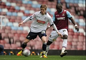 Images Dated 4th February 2012: Clash at Upton Park: Andrew Keogh vs. Abdoulaye Faye in Npower Championship Showdown (Millwall vs)