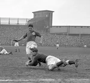 Intense Moment: Ken Chisholm Tackles Malcolm Finlayson in Millwall vs Leeds United Soccer Match