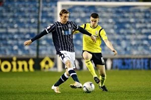 Images Dated 25th March 2014: Millwall vs Birmingham City: A Championship Showdown - Woolford Clears the Threat at The Den
