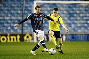 Season 2013-14 Prints: Millwall vs Birmingham City: A Championship Showdown - Woolford Clears the Threat at The Den