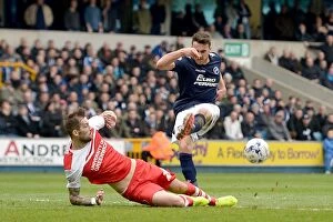 Images Dated 3rd April 2015: Millwall vs Charlton Athletic: Intense Clash at The Den - Roger Johnson Defends Against Lee