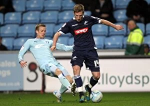 Images Dated 17th April 2012: Millwall vs Coventry City: Clash at Ricoh Arena - James Henry vs Carl Baker