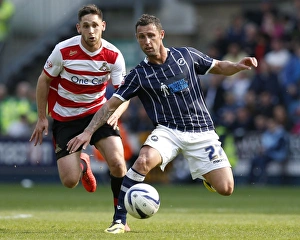 Season 2013-14 Prints: Millwall vs Doncaster Rovers: Scott McDonald Scores Past Dean Furman in Sky Bet Championship Clash at The New Den