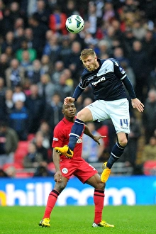 Season 2012-13 Prints: Millwall vs Wigan Athletic: FA Cup Semi-Final Showdown at Wembley Stadium - James Henry Leaps for a Header